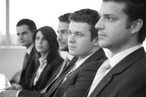 Group of business people listening to someone speak